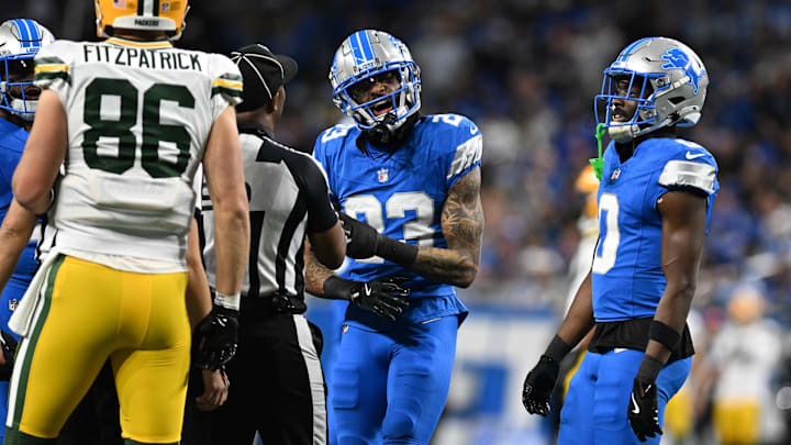 Dec 5, 2024; Detroit, Michigan, USA;  Detroit Lions cornerback Carlton Davis III (23) and Green Bay Packers tight end John FitzPatrick (86) exchange words in the second quarter at Ford Field. Mandatory Credit: Lon Horwedel-Imagn Images