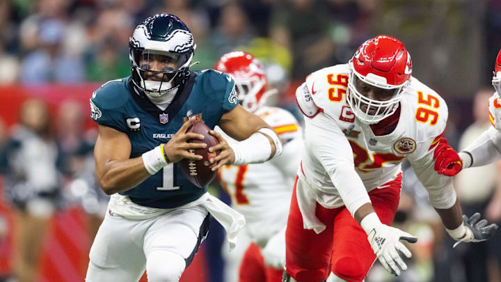 Feb 9, 2025; New Orleans, LA, USA; Philadelphia Eagles quarterback Jalen Hurts (1) is pressured by Kansas City Chiefs defensive tackle Chris Jones (95) during Super Bowl LIX at Ceasars Superdome. Mandatory Credit: Mark J. Rebilas-Imagn Images