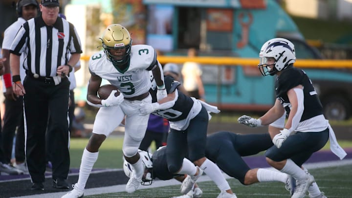 Iowa City West’s Julian Manson (3) attempts to gain additional yards against Iowa City Liberty’s defense Friday, Aug. 30, 2024 in North Liberty, Iowa. Iowa City West’s Julian Manson (3) attempts to gain additional yards against Iowa City Liberty’s defense Friday, Aug. 30, 2024 in North Liberty, Iowa.