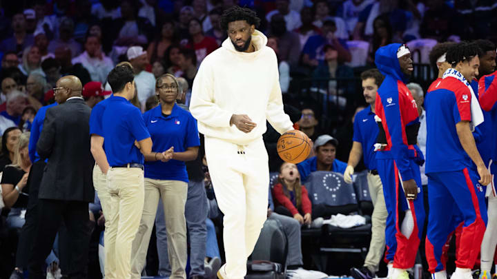  Philadelphia 76ers center Joel Embiid  in plain clothes dribbles the ball during a timeout in the second quarter against the Milwaukee Bucks at Wells Fargo Center. Mandatory Credit: Bill Streicher-Imagn Images
