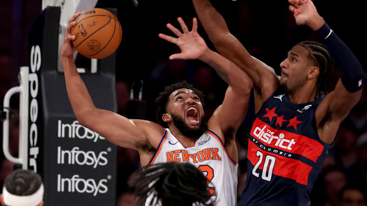 Nov 18, 2024; New York, New York, USA; New York Knicks center Karl-Anthony Towns (32) takes a shot against Washington Wizards forward Alexandre Sarr (20) during the second quarter at Madison Square Garden. Mandatory Credit: Brad Penner-Imagn Images