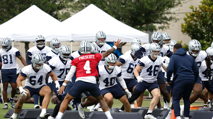 Dallas Cowboys quarterback Dak Prescott leads teammates through a drill at the Ford Center at the Star Training Facility.