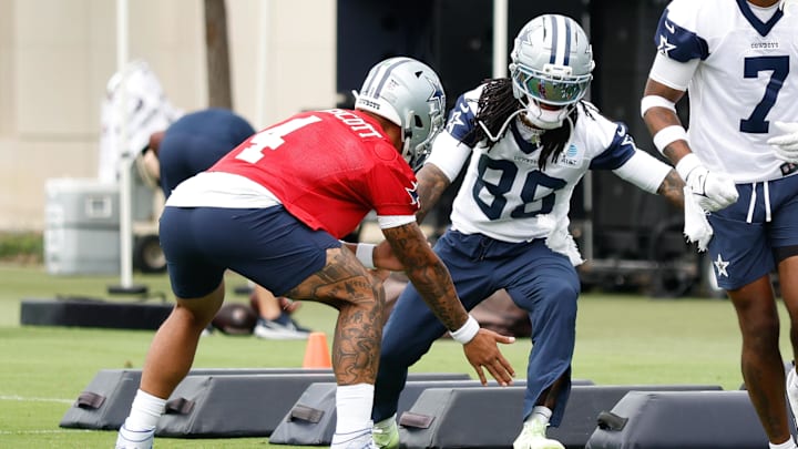 Dallas Cowboys quarterback Dak Prescott celebrates with CeeDee Lamb during a drill at the Ford Center at The Star in Frisco.