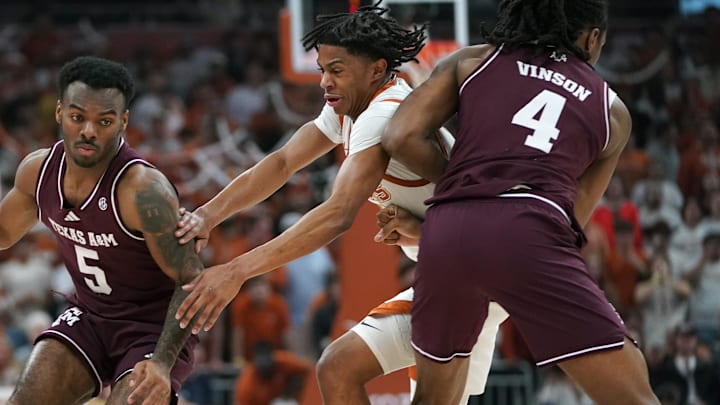 Texas Longhorns guard Simeon Wilcher (7) is picked by Texas A&M Aggies forward Jamie Vinson (4) during the first half at Moody Center.