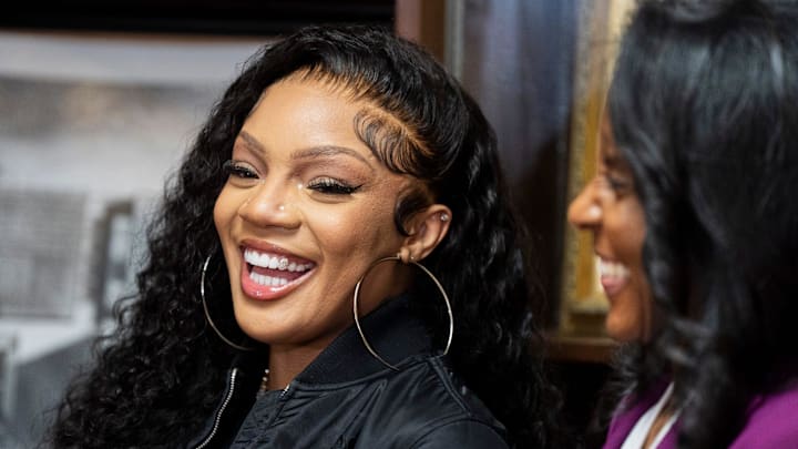 Rapper GloRilla smiles during a press conference to present a check for $25,000 to Melrose High School, where she graduated.