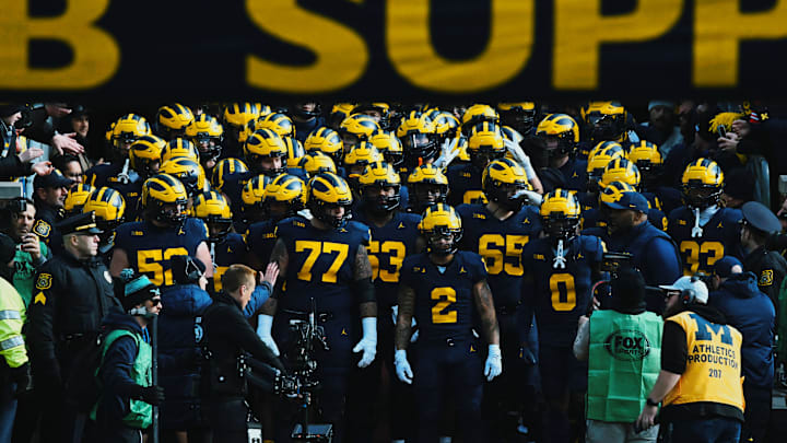 The Michigan Wolverines enter Michigan Stadium