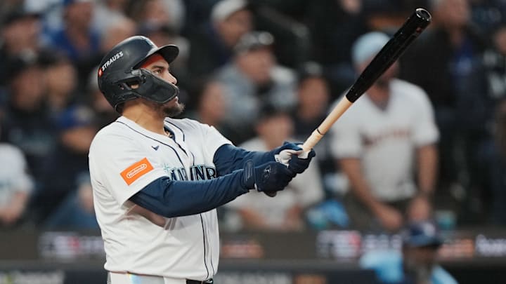 Oct 16, 2025; Seattle, Washington, USA; Seattle Mariners first baseman Josh Naylor (12) hits a solo home run against the Toronto Blue Jays in the second inning during game four of the ALCS round for the 2025 MLB playoffs at T-Mobile Park. Mandatory Credit: Stephen Brashear-Imagn Images