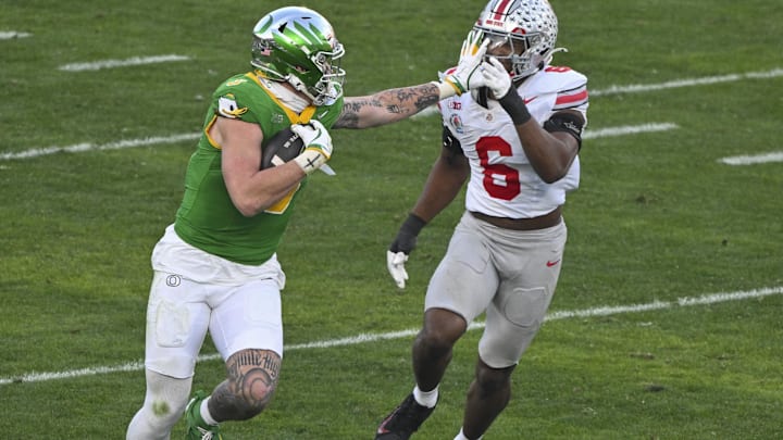 Jan 1, 2025; Pasadena, CA, USA; Oregon Ducks tight end Terrance Ferguson (3) stiff arms Ohio State Buckeyes safety Lathan Ransom (8) during a third quarter pass play at Rose Bowl Stadium. Mandatory Credit: Robert Hanashiro-Imagn Images