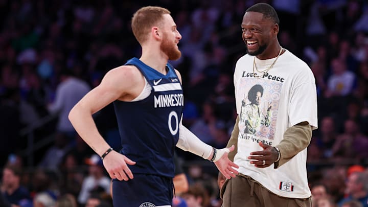 Minnesota Timberwolves guard Donte DiVincenzo (0) celebrates with forward Julius Randle during the first half against the New York Knicks at Madison Square Garden in New York on Oct. 13, 2024.