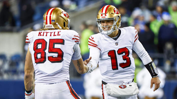 Dec 15, 2022; Seattle, Washington, USA; San Francisco 49ers quarterback Brock Purdy (13) celebrates with tight end George Kittle (85) during the late fourth quarter against the Seattle Seahawks at Lumen Field. Mandatory Credit: Joe Nicholson-Imagn Images