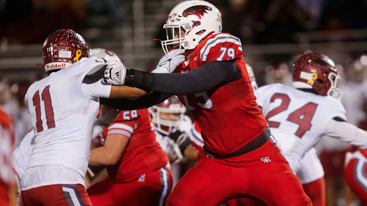 Nixa Eagles Jackson Cantwell holds back a Joplin defender during the championship game of Class 6 District 5 football at Nixa on Friday, Nov. 11, 2023.