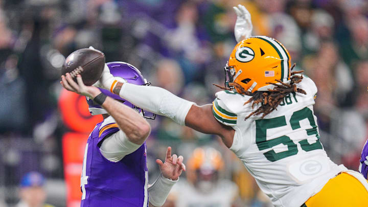 Dec 29, 2024; Minneapolis, Minnesota, USA; Green Bay Packers defensive end Arron Mosby (53) tips the pass against Minnesota Vikings quarterback Sam Darnold (14) in the fourth quarter at U.S. Bank Stadium. Mandatory Credit: Brad Rempel-Imagn Images