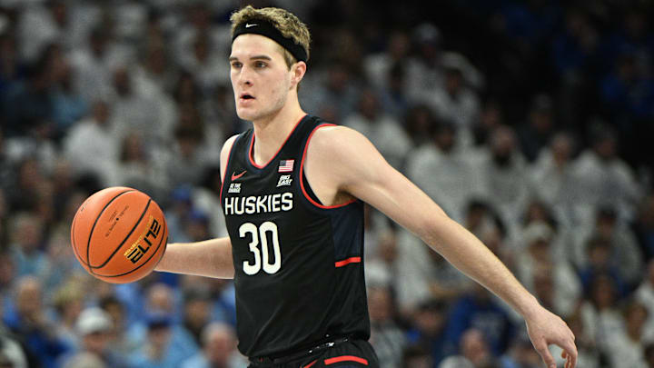 Feb 11, 2025; Omaha, Nebraska, USA;  Connecticut Huskies forward Liam McNeeley (30) dribbles against the Creighton Bluejays during the first half at CHI Health Center Omaha. Mandatory Credit: Steven Branscombe-Imagn Images