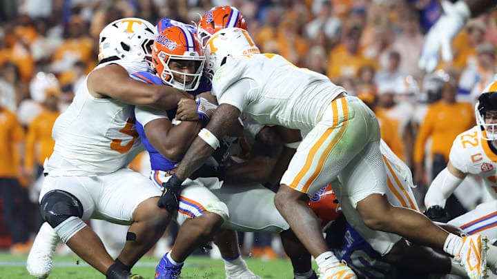 Nov 22, 2025; Gainesville, Florida, USA; Tennessee Volunteers defensive lineman Jaxson Moi (51) and linebacker Arion Carter (7) tackle Florida Gators quarterback DJ Lagway (2) during the first half at Ben Hill Griffin Stadium. Mandatory Credit: Kim Klement Neitzel-Imagn Images