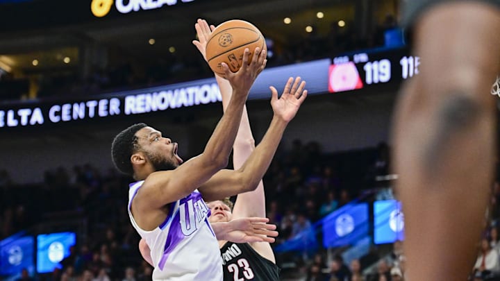 Oct 16, 2025; Salt Lake City, Utah, USA; Utah Jazz guard Elijah Harkless (16) makes layup against Portland Trail Blazers center Donovan Clingan (23) during the second half at Delta Center. Mandatory Credit: Peter Creveling-Imagn Images