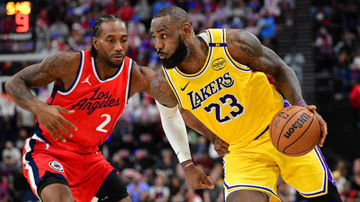 Feb 4, 2025; Inglewood, California, USA; Los Angeles Lakers forward LeBron James (23) moves the ball against Los Angeles Clippers forward Kawhi Leonard (2) during the second half at Intuit Dome. Mandatory Credit: Gary A. Vasquez-Imagn Images