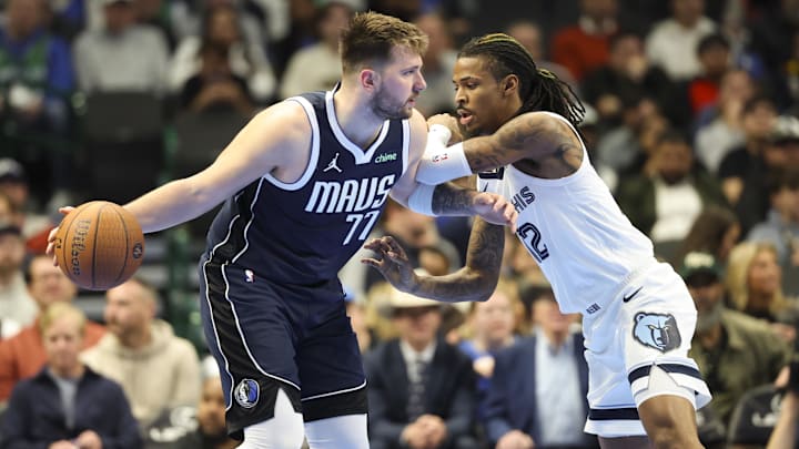 Dec 3, 2024; Dallas, Texas, USA;  Dallas Mavericks guard Luka Doncic (77) controls the ball as Memphis Grizzlies guard Ja Morant (12) defends  during the second half at American Airlines Center. Mandatory Credit: Kevin Jairaj-Imagn Images