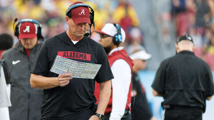 Dec 31, 2024; Tampa, FL, USA; Alabama Crimson Tide head coach Kalen DeBoer reads the playcard against the Michigan Wolverines during the first half at Raymond James Stadium. Mandatory Credit: Matt Pendleton-Imagn Images