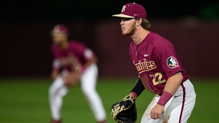 Florida State outfielder James Tibbs III (22) watches a batt4er swing. The Florida Gators defeated