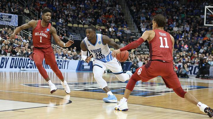 Mar 15, 2018; Pittsburgh, PA, USA;  Rhode Island Rams guard Jared Terrell (32) drives to the basket between Oklahoma Sooners guards Rashard Odomes (1) and Trae Young (11) during the second half in the first round of the 2018 NCAA Tournament at PPG Paints Arena. Rhode Island won 83-78 in overtime. Mandatory Credit: Charles LeClaire-USA TODAY Sports