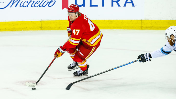 Apr 12, 2026; Calgary, Alberta, CAN; Calgary Flames center Connor Zary (47) controls the puck against the Utah Mammoth during the third period at Scotiabank Saddledome. Mandatory Credit: Sergei Belski-Imagn Images