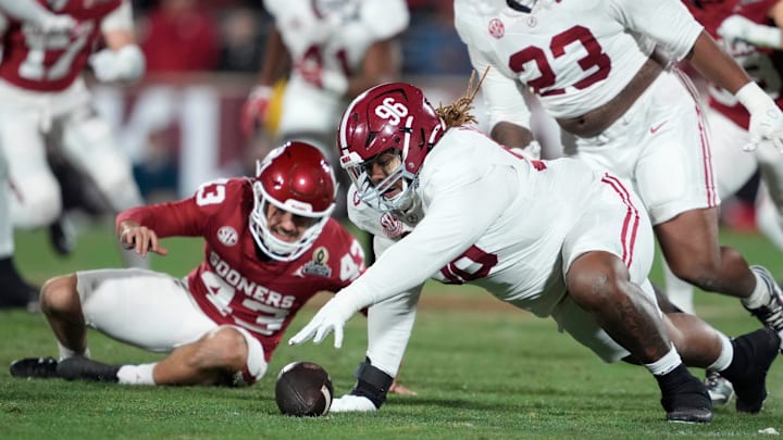 Alabama Crimson Tide defensive lineman Tim Keenan III (96) recovers the ball after blocking the punt of Oklahoma Sooners kicker Grayson Miller (43) during a first-round College Football Playoff game between the University of Oklahoma Sooners (OU) and the Alabama Crimson Tide at Gaylord Family Ð Oklahoma Memorial Stadium in Norman, Okla., Friday, Dec. 19, 2025.