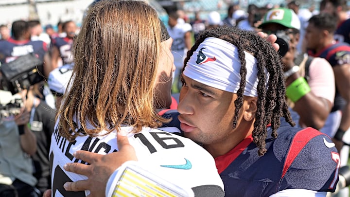 Sep 24, 2023; Jacksonville, Florida, USA; Houston Texans quarterback CJ Stroud (7) and Jacksonville Jaguars quarterback Trevor Lawrence (16) meet at the end of the game at EverBank Stadium. Mandatory Credit: Melina Myers-Imagn Images