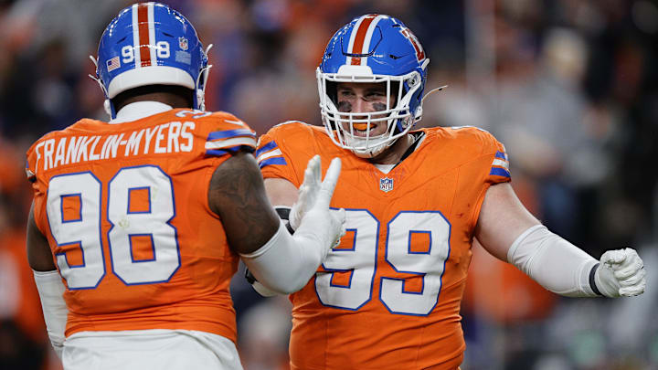 Nov 6, 2025; Denver, Colorado, USA; Denver Broncos defensive end Zach Allen (99) reacts with defensive end John Franklin-Myers (98) during the first half at Empower Field at Mile High. Mandatory Credit: Isaiah J. Downing-Imagn Images Nov 6, 2025; Denver, Colorado, USA; Denver Broncos defensive end Zach Allen (99) reacts with defensive end John Franklin-Myers (98) during the first half at Empower Field at Mile High. Mandatory Credit: Isaiah J. Downing-Imagn Images