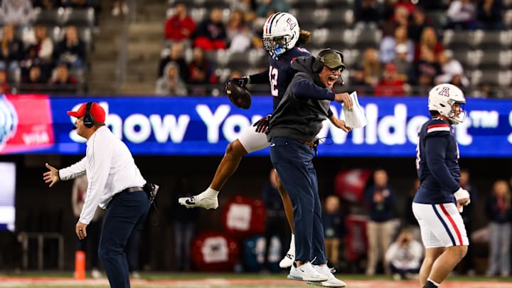 Nov 15, 2024; Tucson, Arizona, USA; Arizona Wildcats defensive back Genesis Smith (2) celebrates catching a fumbled ball with Arizona Wildcats defensive coordinator Duane Akina during the first quarter against the Houston Cougars at Arizona Stadium. =