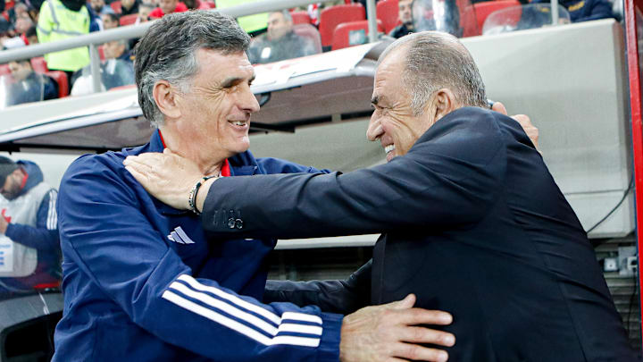 Jose Luis Mendilibar, left, greets Panathinaikos coach Fatih Terim before Sunday's Greek Super League playoff match.
