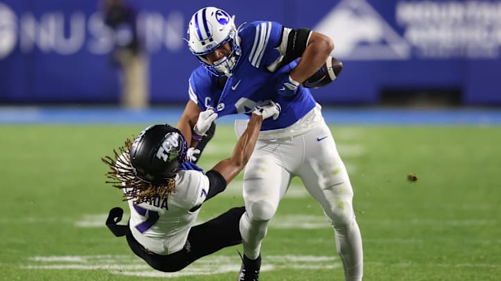 Nov 15, 2025; Provo, Utah, USA; BYU Cougars running back LJ Martin (4) is tackled by Texas Christian University Horned Frogs cornerback Channing Canada (7) during the first quarter at LaVell Edwards Stadium. Mandatory Credit: Rob Gray-Imagn Images Nov 15, 2025; Provo, Utah, USA; BYU Cougars running back LJ Martin (4) is tackled by Texas Christian University Horned Frogs cornerback Channing Canada (7) during the first quarter at LaVell Edwards Stadium. Mandatory Credit: Rob Gray-Imagn Images