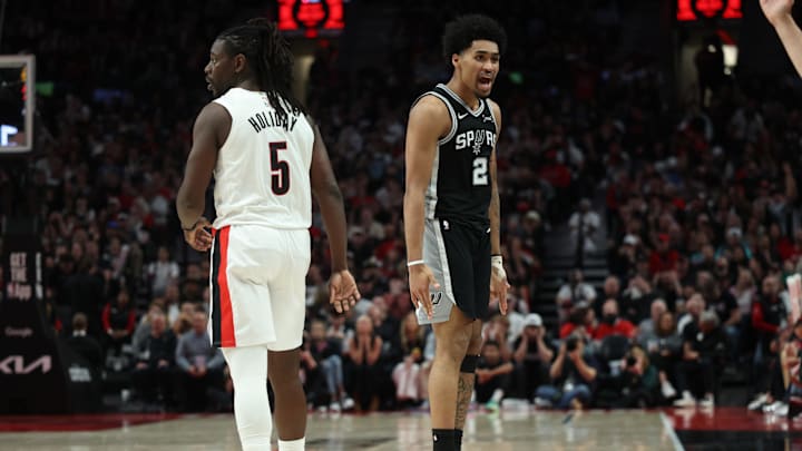 Apr 24, 2026; Portland, Oregon, USA; San Antonio Spurs guard Dylan Harper (2) reacts after scoring against Portland Trail Blazers guard Jrue Holiday (5) during the second half during game three of the first round of the 2026 NBA Playoffs at Moda Center. Mandatory Credit: Jaime Valdez-Imagn Images