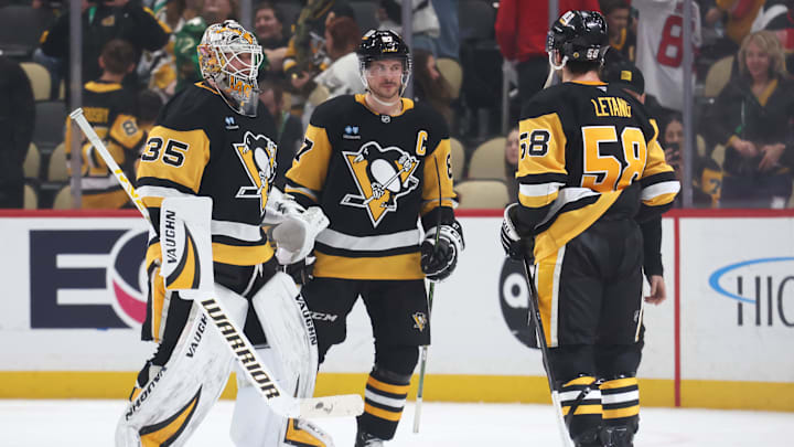 Mar 15, 2025; Pittsburgh, Pennsylvania, USA;  Pittsburgh Penguins goaltender Tristan Jarry (35) and center Sidney Crosby (87) and defenseman Kris Letang (58) celebrate after defeating the New Jersey Devils at PPG Paints Arena. Mandatory Credit: Charles LeClaire-Imagn Images