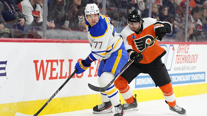 Mar 29, 2025; Philadelphia, Pennsylvania, USA; Buffalo Sabres right wing JJ Peterka (77) controls the puck against Philadelphia Flyers defenseman Jamie Drysdale (9) in the first period at Wells Fargo Center.