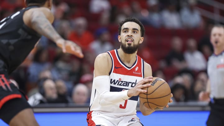 Mar 14, 2024; Houston, Texas, USA; Washington Wizards guard Tyus Jones (5) pulls up to shoot the ball during the third quarter against the Houston Rockets at Toyota Center. Mandatory Credit: Troy Taormina-USA TODAY Sports