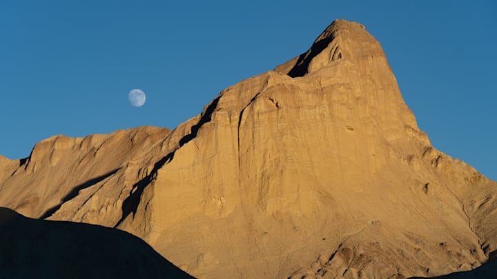 Moon rising over Badlands, Death Valley National Park, California.