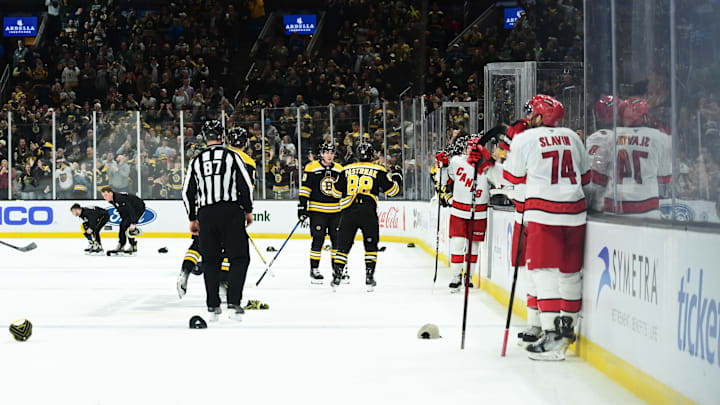 Apr 5, 2025; Boston, Massachusetts, USA; Hats are thrown on the ice after Boston Bruins right wing David Pastrnak (88) gets a hat trick during the third period against the Carolina Hurricanes at TD Garden. Mandatory Credit: Bob DeChiara-Imagn Images
