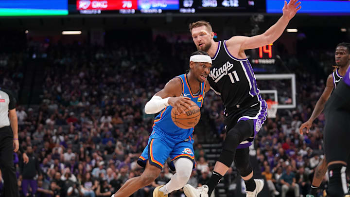Mar 25, 2025; Sacramento, California, USA; Oklahoma City Thunder guard Shai Gilgeous-Alexander (2) dribbles the ball in front of Sacramento Kings center Domantas Sabonis (11) in the third quarter at the Golden 1 Center. Mandatory Credit: Cary Edmondson-Imagn Images