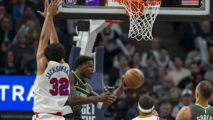 Minnesota Timberwolves guard Anthony Edwards drives to the basket past Golden State Warriors forward Trayce Jackson-Davis (32) and looks to pass the ball in the second half at Target Center in Minneapolis on Dec. 21, 2024.