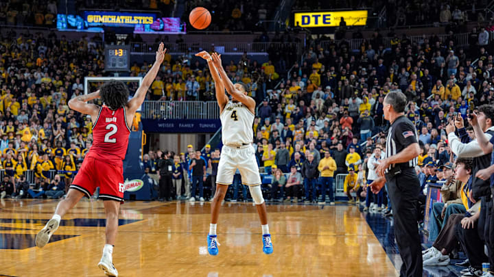 Michigan Wolverines guard Nimari Burnett (4) shoots the game-winning 3-pointer over Rutgers Scarlet Knights guard Dylan Harper (2) during the second half at Crisler Center in Ann Arbor on Thursday, Feb. 27, 2025.