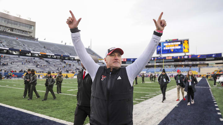 Nov 29, 2025; Morgantown, West Virginia, USA; Texas Tech Red Raiders head coach Joey McGuire celebrates with fans after defeating the West Virginia Mountaineers at Milan Puskar Stadium. Mandatory Credit: Ben Queen-Imagn Images