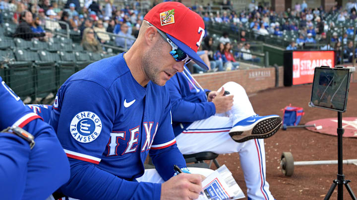 Texas Rangers manager Skip Schumaker (55) checks his lineup card.