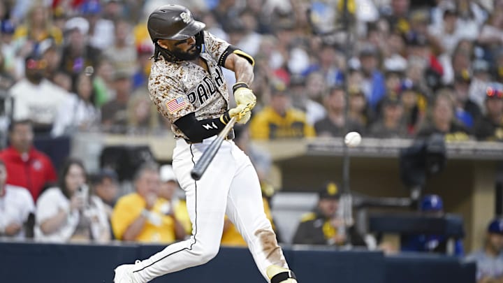 Jul 6, 2025; San Diego, California, USA; San Diego Padres right fielder Fernando Tatis Jr. (23) hits an RBI double during the fourth inning against the Texas Rangers at Petco Park. Mandatory Credit: Denis Poroy-Imagn Images