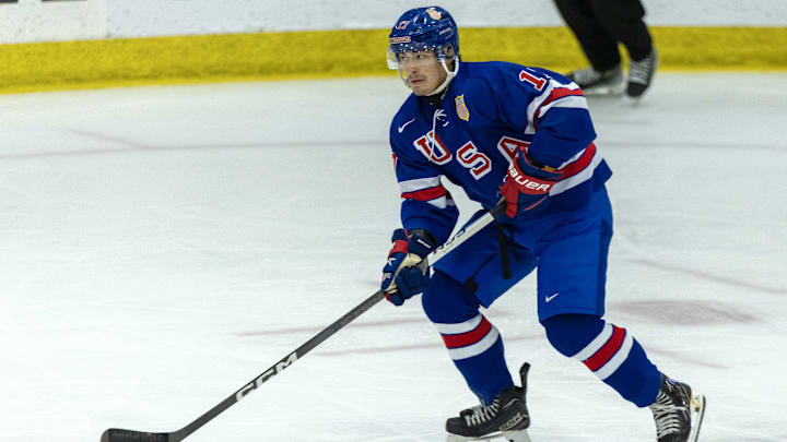Aug 3, 2024; Plymouth, MI, USA; USA’s defenceman Aram Minnetian (17) skates up ice with the puck against Canada during the first period of the 2024 World Junior Summer Showcase at USA Hockey Arena. Mandatory Credit: David Reginek-Imagn Images