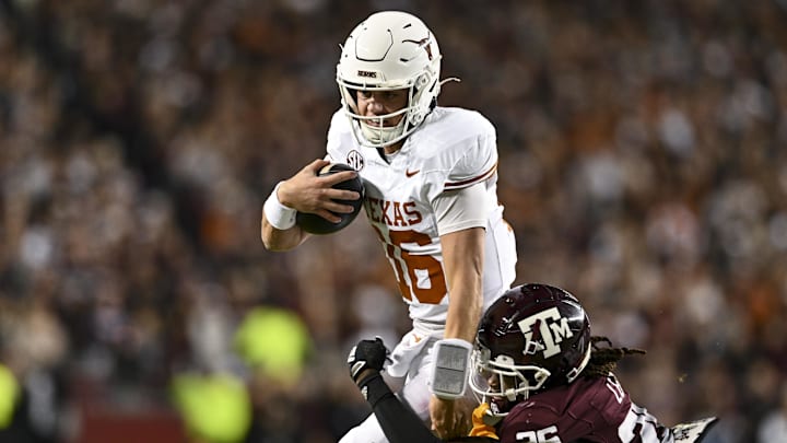 Nov 30, 2024; College Station, Texas, USA; Texas Longhorns quarterback Arch Manning (16) runs the ball as Texas A&M Aggies defensive back Dashawn Fillmore (26) defends during the second quarter at Kyle Field. Mandatory Credit: Maria Lysaker-Imagn Images 