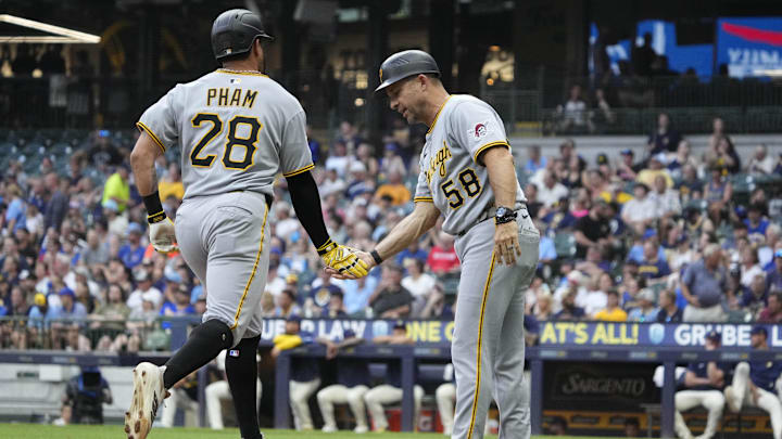 Jun 23, 2025; Milwaukee, Wisconsin, USA; Pittsburgh Pirates third base coach Mike Rabelo (58) congratulates outfielder Tommy Pham (28) after hitting a home run against the Milwaukee Brewers in the fourth inning at American Family Field. Mandatory Credit: Michael McLoone-Imagn Images