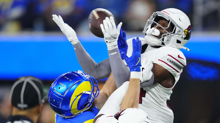 Dec 28, 2024; Inglewood, California, USA; Arizona Cardinals safety Jalen Thompson (34) and Los Angeles Rams wide receiver Cooper Kupp (10) attempt to catch the ball in the second half at SoFi Stadium. Mandatory Credit: Kirby Lee-Imagn Images