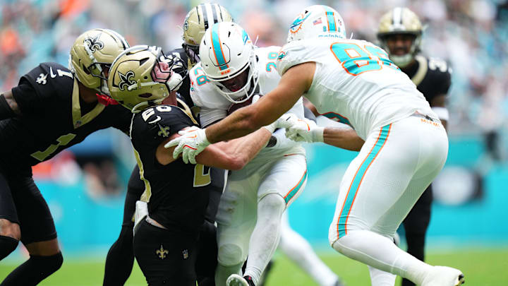 Miami Dolphins running back De'Von Achane (28) is tackled by New Orleans Saints linebacker Pete Werner (20) during the first half at Hard Rock Stadium. Miami Dolphins running back De'Von Achane (28) is tackled by New Orleans Saints linebacker Pete Werner (20) during the first half at Hard Rock Stadium.