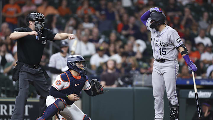 Rockies catcher Hunter Goodman, right, requests an ABS challenge while he's rung up on strikes by the umpire.