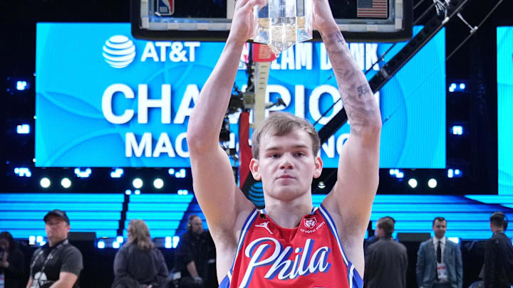 Feb 18, 2023; Salt Lake City, UT, USA; Philadelphia 76ers guard Mac McClung (9) celebrates with the trophy after winning the Dunk Contest during the 2023 All Star Saturday Night at Vivint Arena. Mandatory Credit: Kyle Terada-Imagn Images